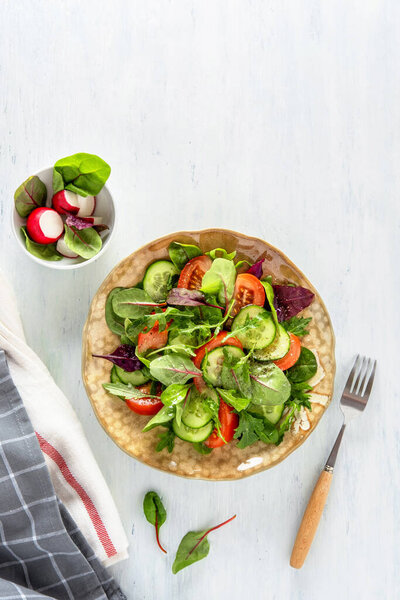 Summer healthy vegetables salad with cucumber, radish, micro greens and tomato. Summer healthy vegetable salad.