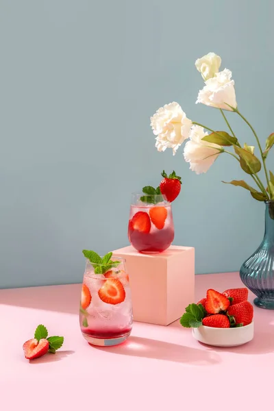 草莓Mojito蓝色背景和粉色讲台 以复印空间更新夏季饮品 图库照片