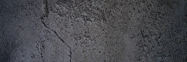 abstract textured dark gray or black surface texture rough background, cement concrete floor or wall. banner