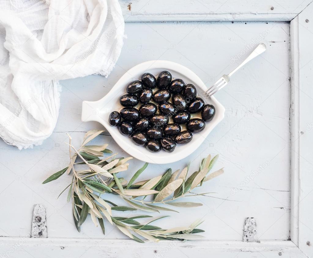 Black olives in white ceramic plate