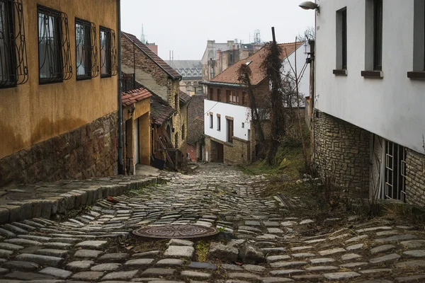 Old medieval narrow stone paved street — Stock Photo, Image