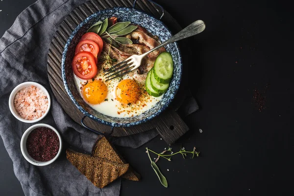 Pan of fried eggs with bacon — Stock Photo, Image