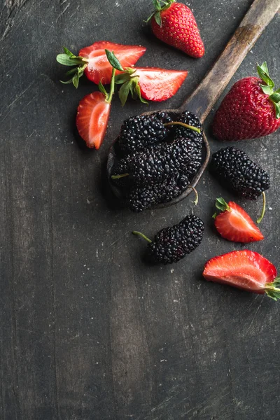 Berries on dark wooden background — Stock Photo, Image