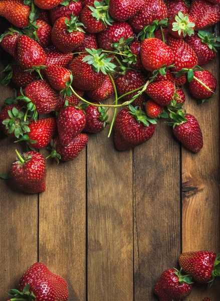 Strawberries over natural wooden background — Stock Photo, Image