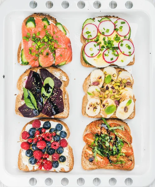 Sweet and savory breakfast toasts assortment — Stock Photo, Image