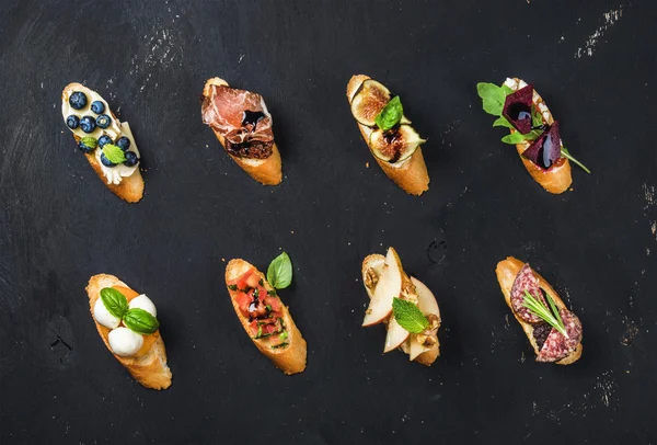 Italian crostini with various toppings — Stock Photo, Image