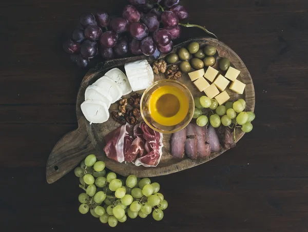 Wine appetizers set: meat and cheese selection, honey, grapes, w