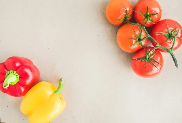 Vegetable set: ripe tomatoes, red and yellow paprikat on a craft — Stock Photo, Image