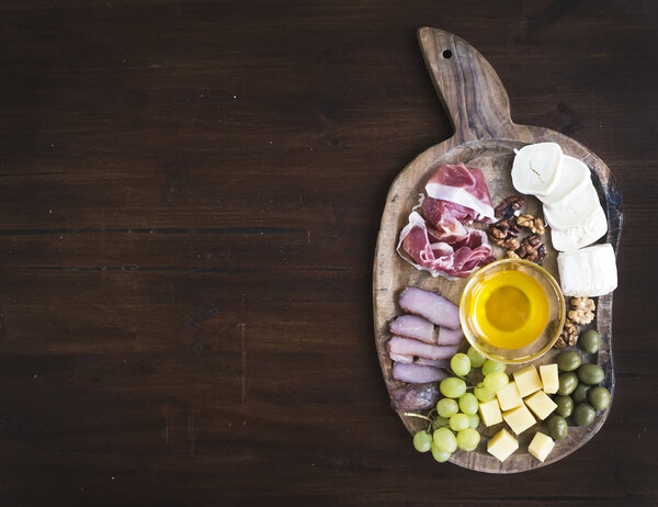 Wine appetizers set: meat and cheese selection, honey, grapes, w