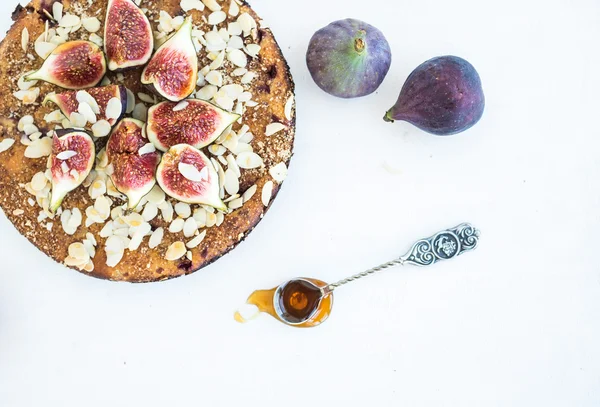 Fig cake with fresh figs, honey and almond flakes on white — Stock Photo, Image