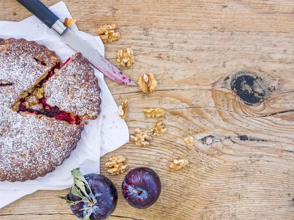 Plum cake with walnuts and fresh ripe plums