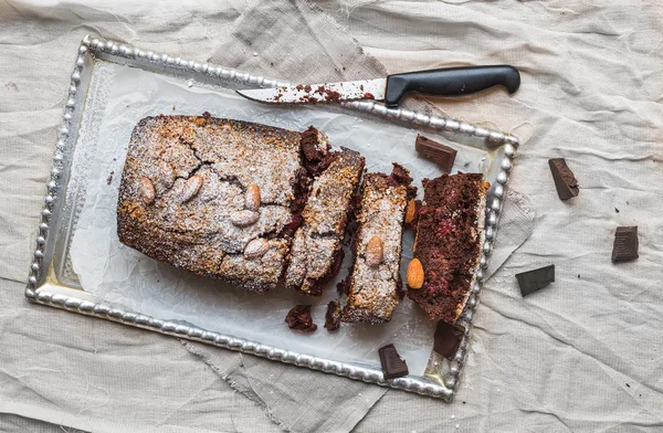 Cherry brownie with almond and dark chocolate cut into pieces on — Stock Photo, Image