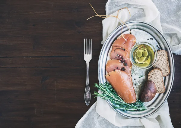 Appetizer set: chicken carpaccio, bread, olives, spices and rose — Stock Photo, Image