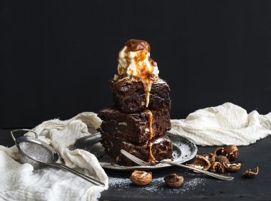 Fudgy Brownies tower with salted caramel, walnuts and ice-cream clipart