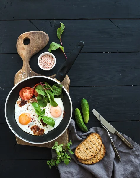 Pan of fried eggs, bacon, tomatoes — ストック写真