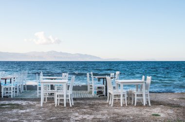 Chairs and tables in old cafe near the sea