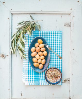Green big olives in rustic ceramic plate