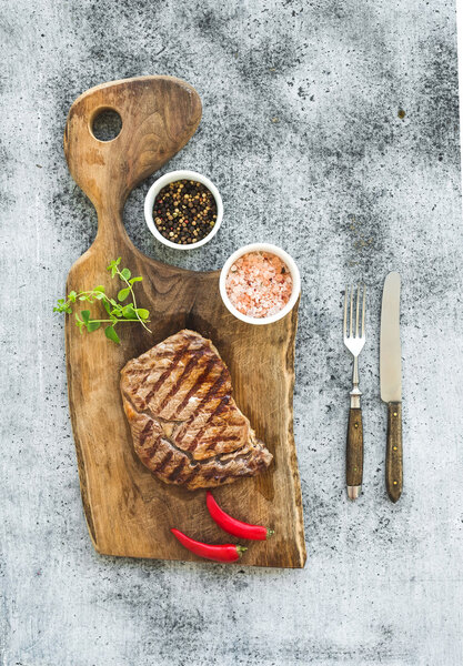 Grilled ribeye beef steak with herbs