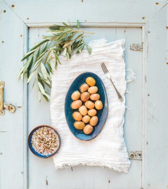 Green big olives in rustic ceramic plate