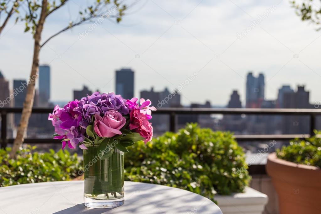 Floral arangement with Roses, Hydrangea, Orchids with city background
