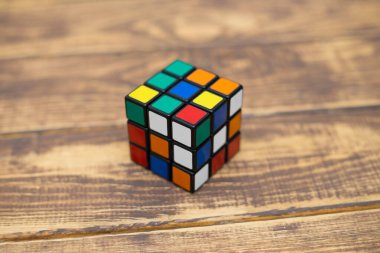 Renkli 3B kombinasyon Rubik küpü 3 'er 3' er tahta bir masada yatıyor.