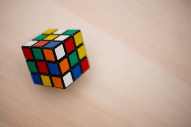 Renkli 3B kombinasyon Rubik küpü 3 'er 3' er tahta bir masada yatıyor.