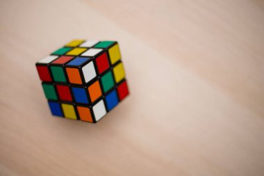 Renkli 3B kombinasyon Rubik küpü 3 'er 3' er tahta bir masada yatıyor.