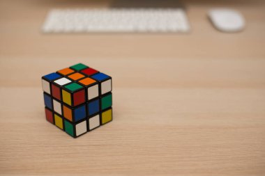 Renkli 3B kombinasyon Rubik küpü 3 'er 3' er tahta bir masada yatıyor.