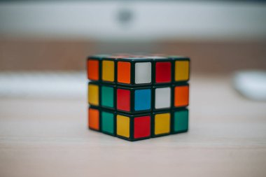 Renkli 3B kombinasyon Rubik küpü 3 'er 3' er tahta bir masada yatıyor.