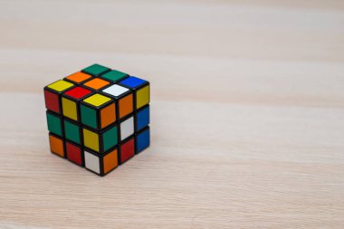Renkli 3B kombinasyon Rubik küpü 3 'er 3' er tahta bir masada yatıyor.