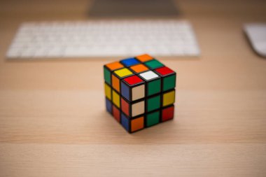 Renkli 3B kombinasyon Rubik küpü 3 'er 3' er tahta bir masada yatıyor.