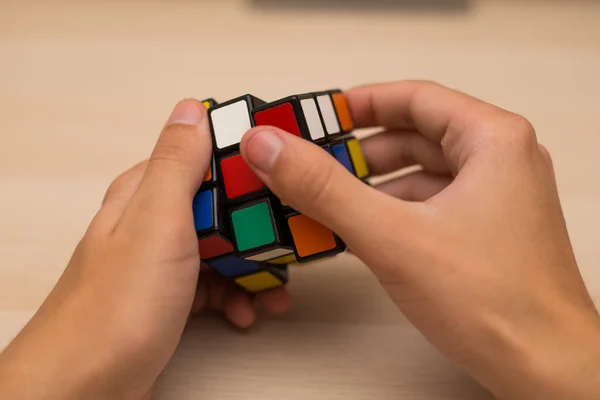 Hand Holds Colored Puzzle Rubik Cube Three Three Lies Wooden — Stock Photo, Image