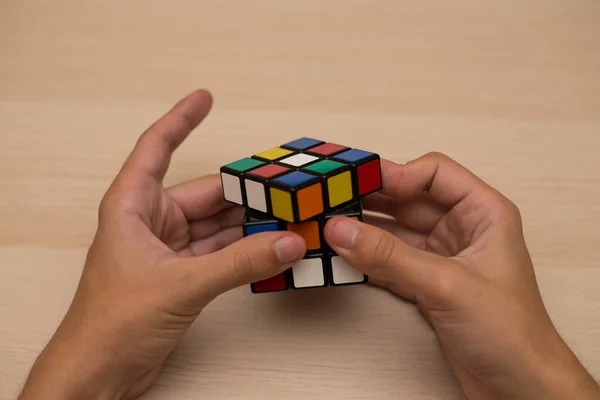 Hand Holds Colored Puzzle Rubik Cube Three Three Lies Wooden — Stock Photo, Image