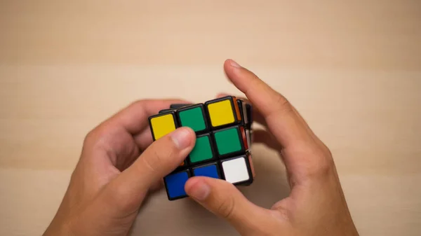 Hand Holds Colored Puzzle Rubik Cube Three Three Lies Wooden — Stock Photo, Image