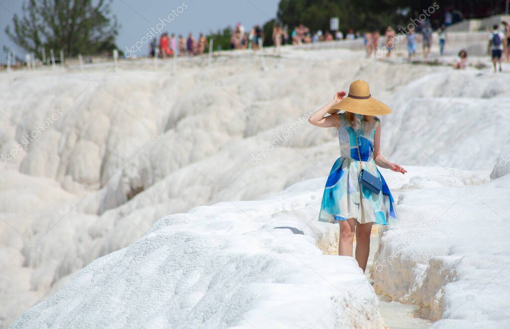 Beautiful girl in a hat and dress in Pamukkale in Turke
