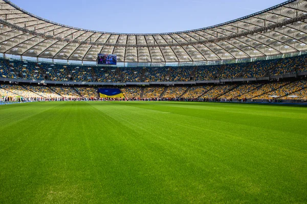 Ukrayna bayrağı ve futbol olimpiyat stadyumunda sarı ve mavi banklarla kalabalık