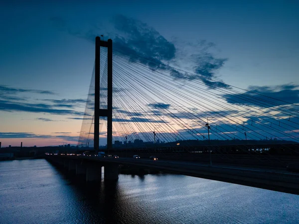 Widok z lotu ptaka na most linowy na rzece wieczorem — Zdjęcie stockowe