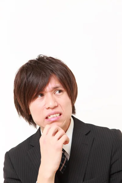 Young Japanese businessman worries about something — Stock Photo, Image