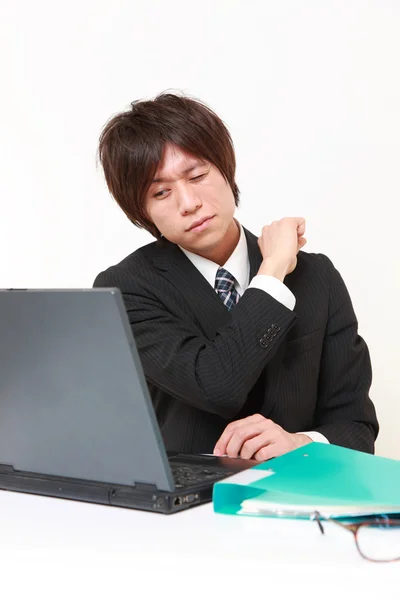 Young Japanese businessman suffers from neck ache — Stock Photo, Image