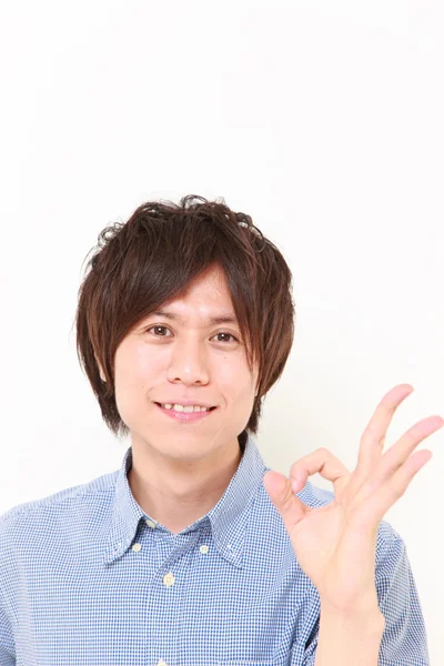 Young Japanese man showing perfect sign — Stock Photo, Image