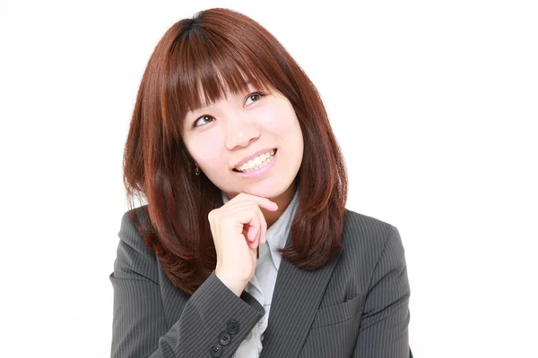 Portret van een jonge Japanse zakenvrouw denkt over iets — Stockfoto