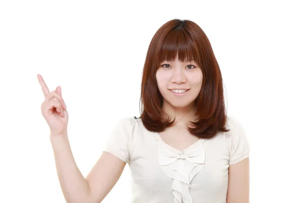 Young Japanese woman presenting and showing something — Stock Photo, Image