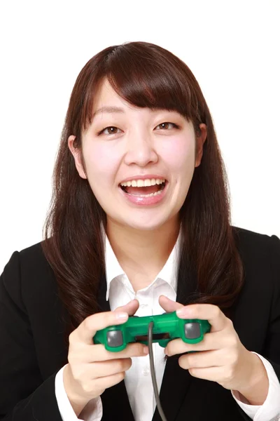 Jovem empresária japonesa desfrutando de um jogo de vídeo — Fotografia de Stock