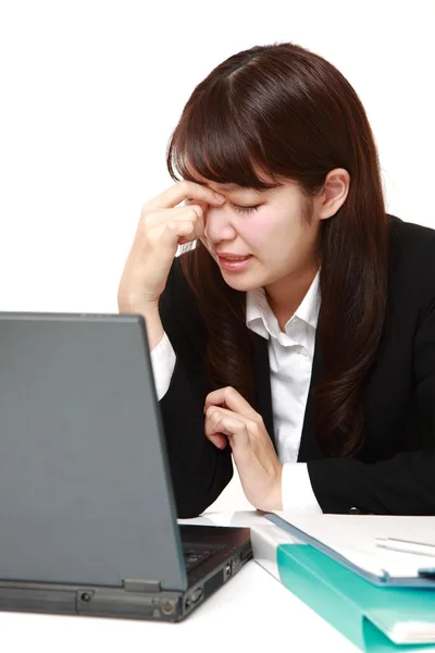 Young Japanese businesswoman suffers from Asthenopia — Stock Photo, Image