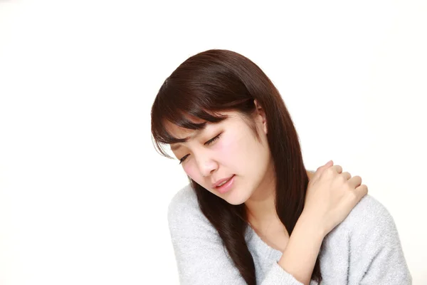 Young Japanese woman suffers from neck ache — Stock Photo, Image