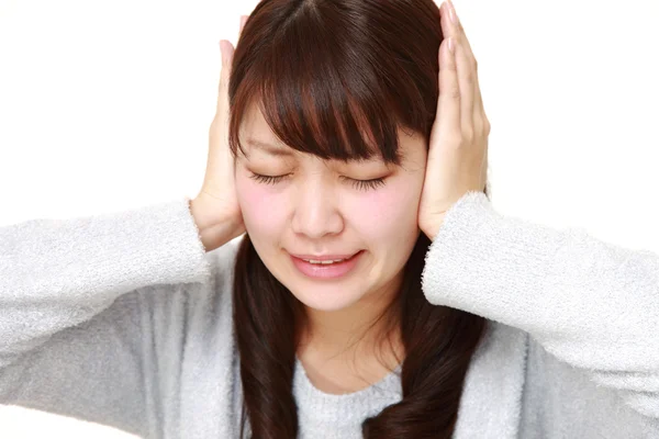 Young Japanese woman suffers from noise — Stock Photo, Image