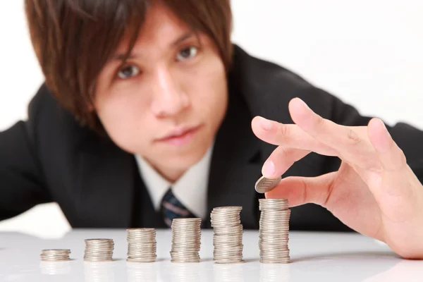 Businessman Put Coins To Stack Of Coins Royalty Free Stock Images