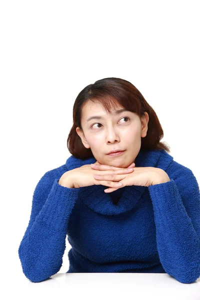 Asian woman thinks about something — Stock Photo, Image