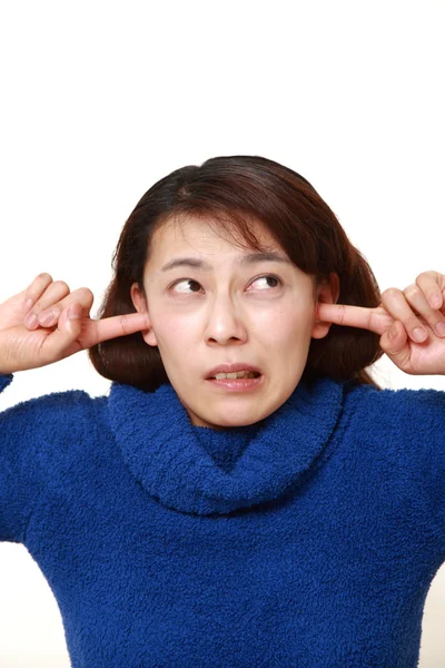 Asian woman suffers from noise — Stock Photo, Image