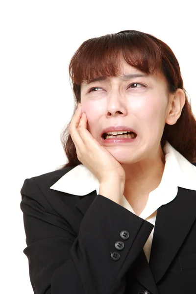 Asian businesswoman suffers from toothache Stock Photo